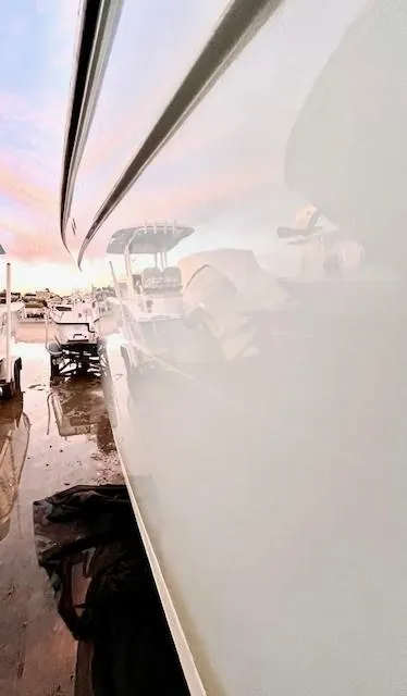 Slide: The Image of Century 24 Resorter 2020 boat reflecting sunset at marina. - 6