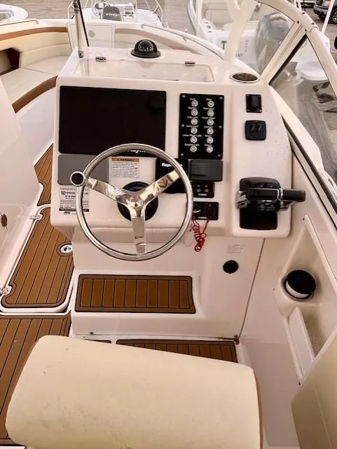 Slide: The Image of 2020 Century 24 Resorter boat dashboard with steering wheel and control panel. - 8