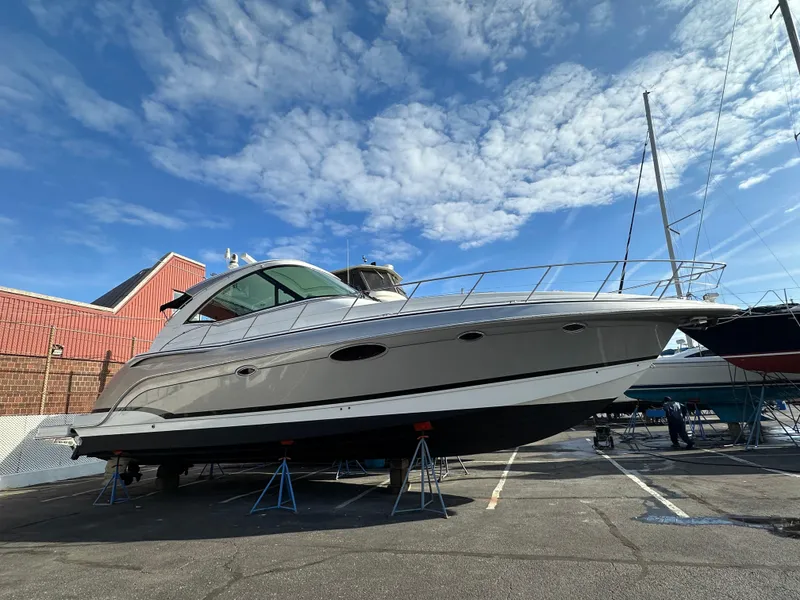 The Image of 2014 Formula 45 Yacht on stands in a marina, under a partly cloudy sky. - 0
