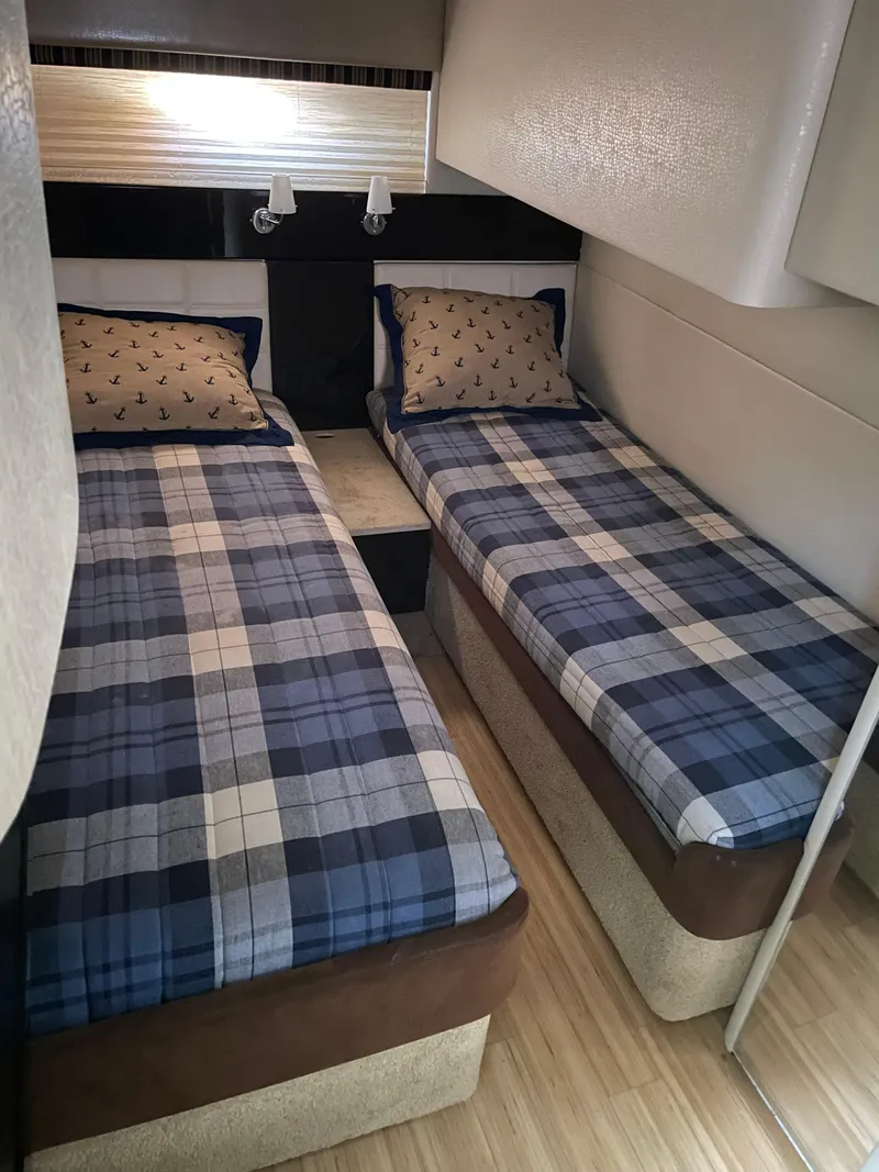 Slide: The Image of Twin beds in a 2014 Formula 45 Yacht cabin with plaid bedding. - 12