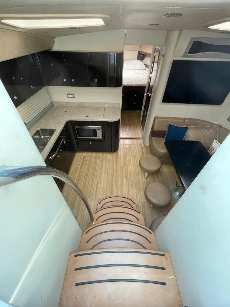 Slide: The Image of Interior of 2014 Formula 45 Yacht featuring kitchen, dining area, and stairs. - 2