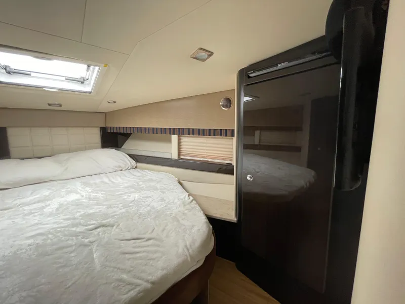 Slide: The Image of 2014 Formula 45 Yacht bedroom with bed, skylight, and sleek cabinetry. - 23