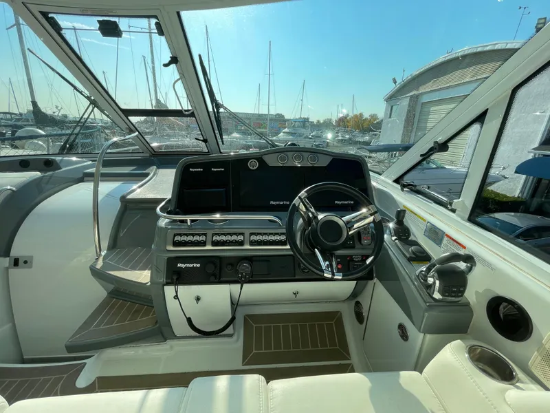 Slide: The Image of 2014 Formula 45 Yacht cockpit with modern steering and navigation controls, docked at marina. - 5