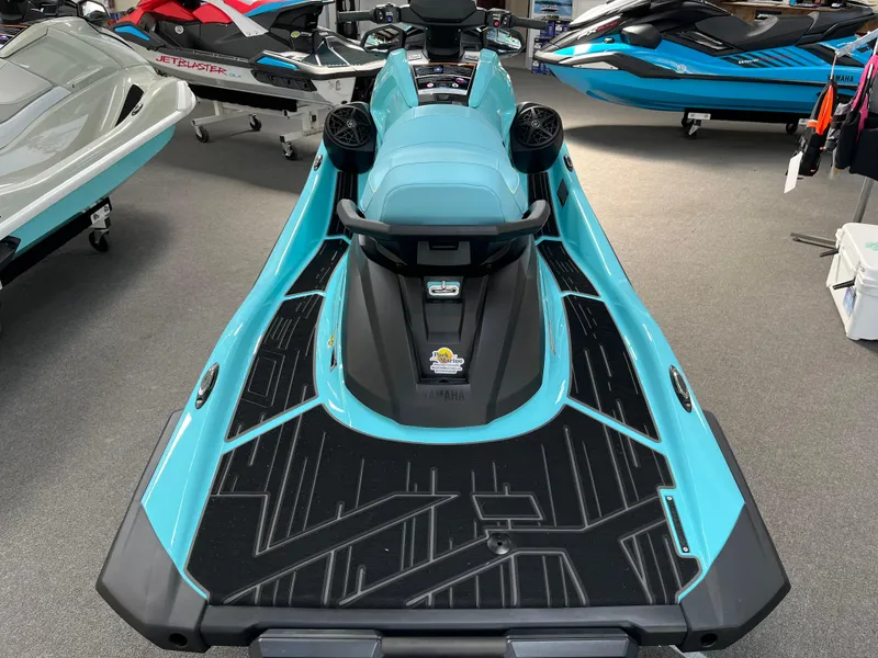 Slide: The Image of 2025 Yamaha WaveRunner VX Limited Ho in showroom, turquoise and black design. - 2