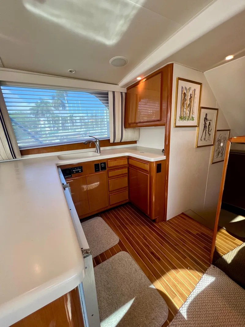 Slide: The Image of Interior of 1999 Viking Conv Sport Fisher yacht with wood flooring and modern kitchen. - 11