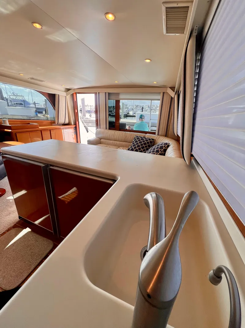 Slide: The Image of Interior of 1999 Viking Conv Sport Fisher yacht with modern kitchen and cozy seating area. - 12