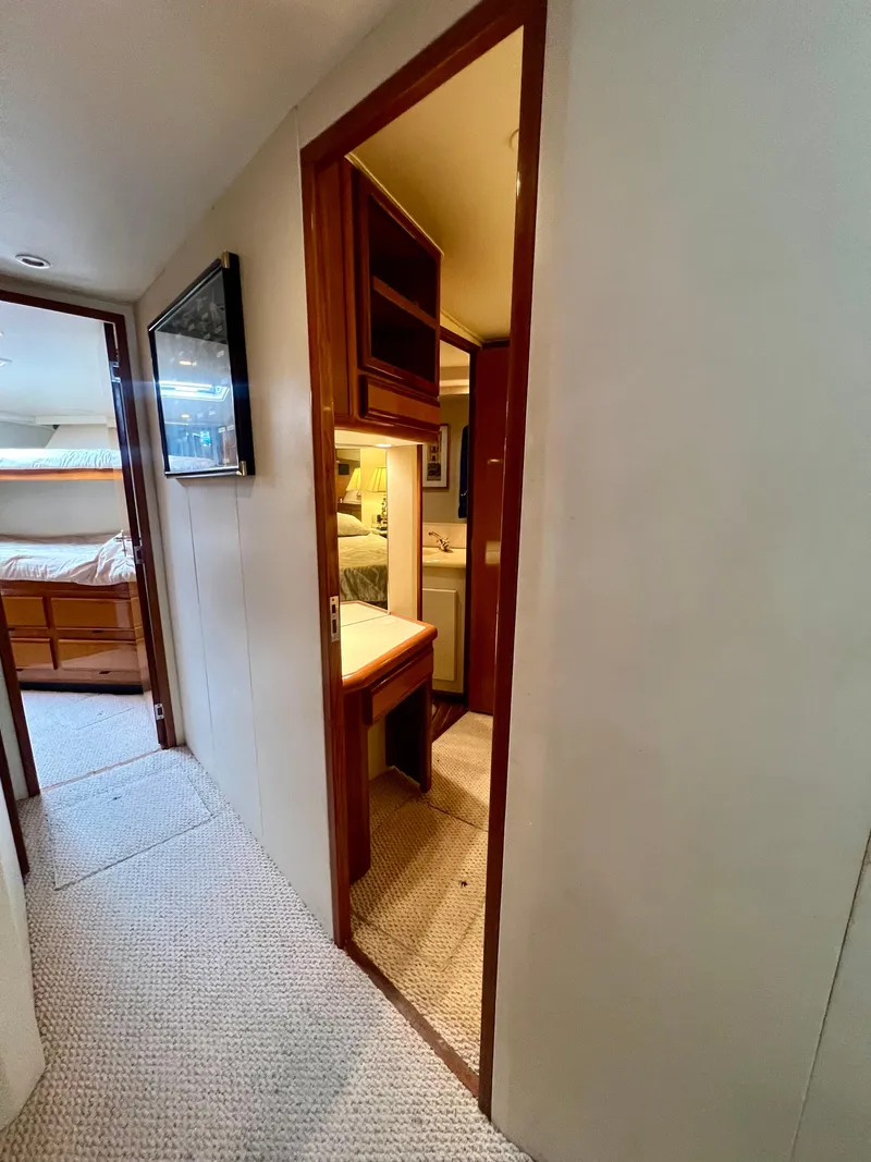 Slide: The Image of Interior of 1999 Viking Conv Sport Fisher yacht with hallway and cabin view. - 13