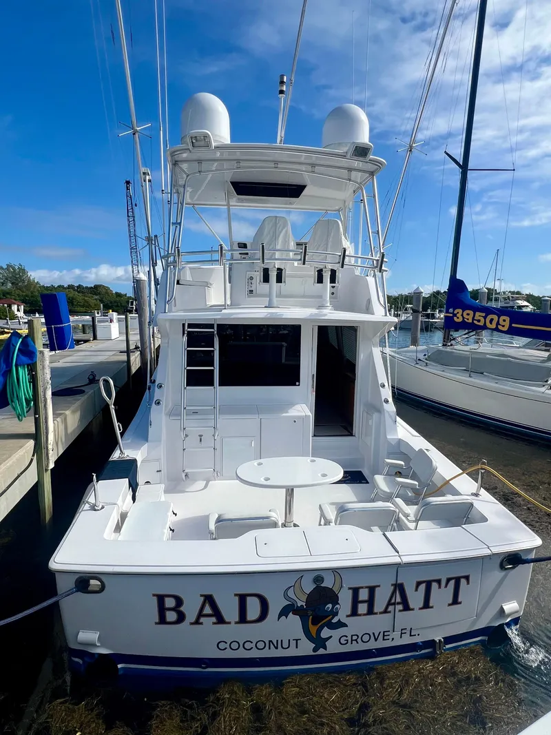 Slide: The Image of 1999 Viking Conv Sport Fisher boat docked, named "Bad Hatt," Coconut Grove, FL. - 2