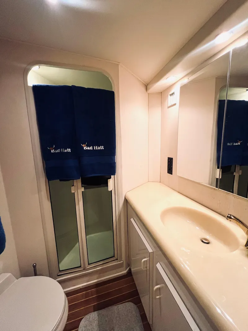 Slide: The Image of 1999 Viking Conv Sport Fisher bathroom with sink, mirror, and window. - 23