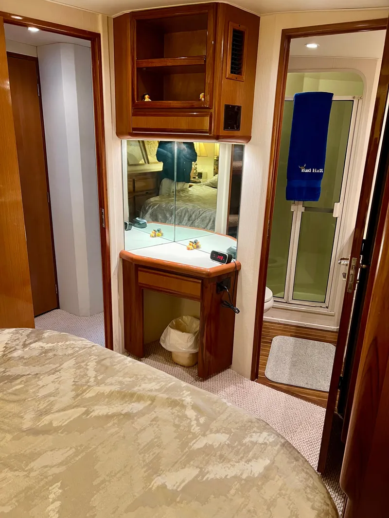 Slide: The Image of Interior of 1999 Viking Conv Sport Fisher yacht with wood cabinetry and cozy decor. - 24