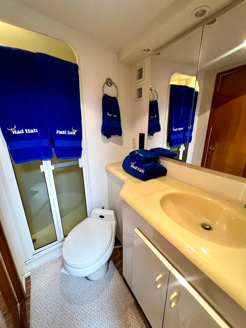 Slide: The Image of Bathroom interior of 1999 Viking Conv Sport Fisher yacht with blue towels and modern fixtures. - 26