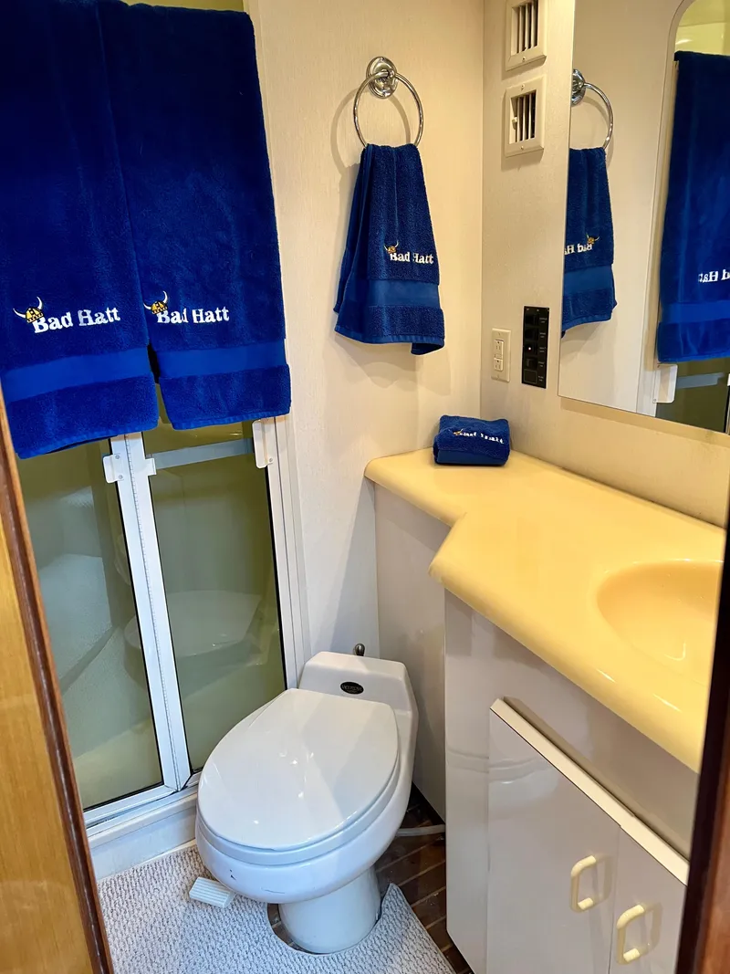 Slide: The Image of Bathroom interior of 1999 Viking Conv Sport Fisher yacht with blue towels and modern fixtures. - 27