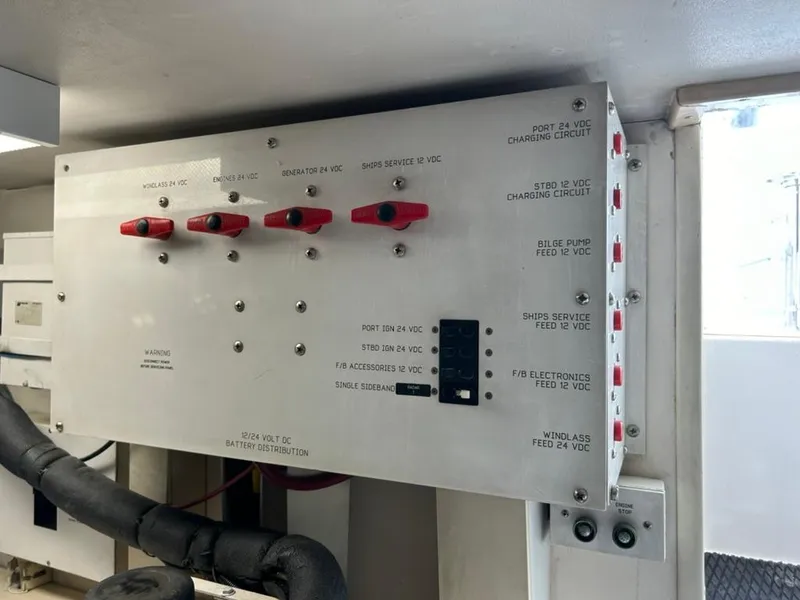 Slide: The Image of Electrical panel on a 1999 Viking Conv Sport Fisher boat, featuring battery distribution switches. - 28
