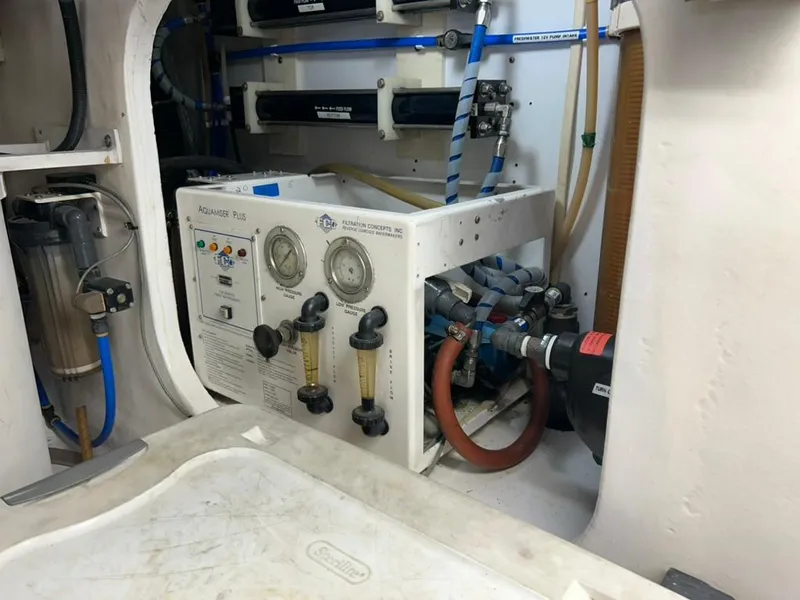 Slide: The Image of Engine room of 1999 Viking Conv Sport Fisher with water filtration system. - 29