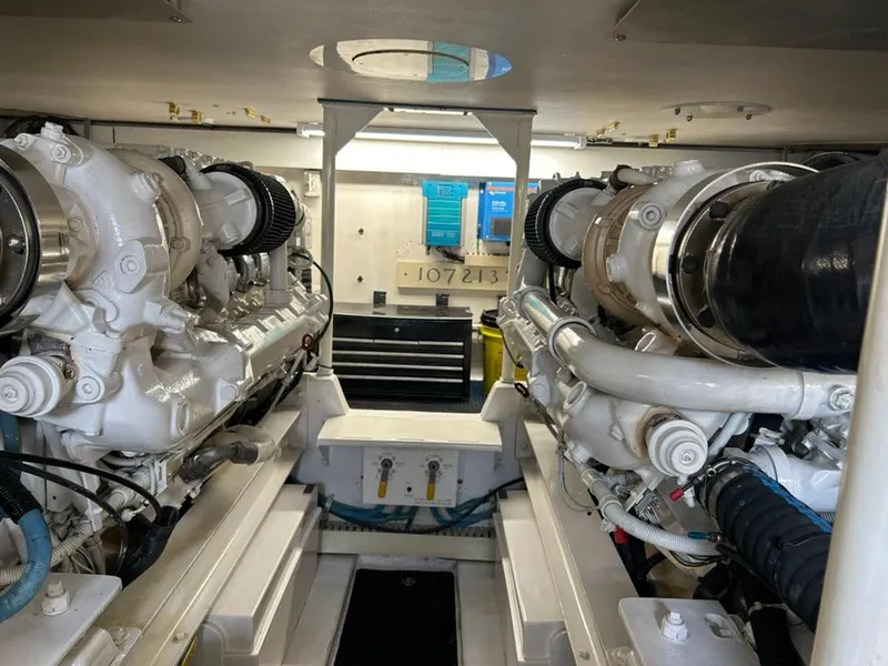 Slide: The Image of Engine room of 1999 Viking Conv Sport Fisher boat, showcasing dual engines and mechanical components. - 32