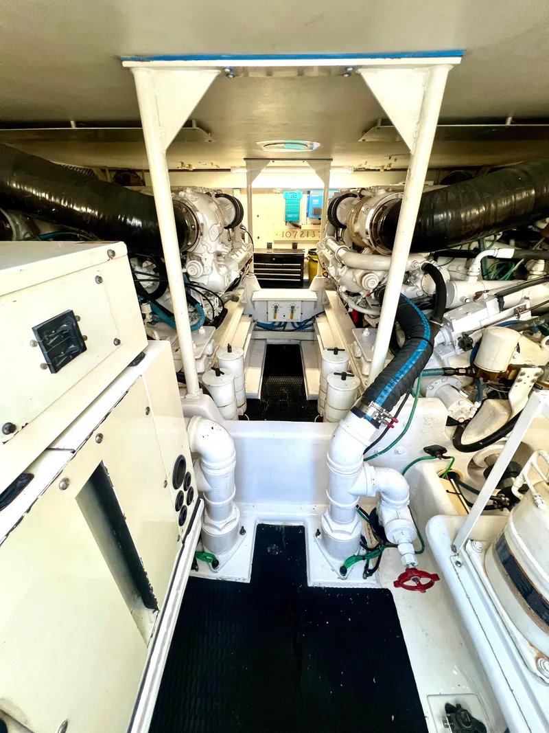 Slide: The Image of Engine room of 1999 Viking Conv Sport Fisher boat, showcasing machinery and equipment. - 33