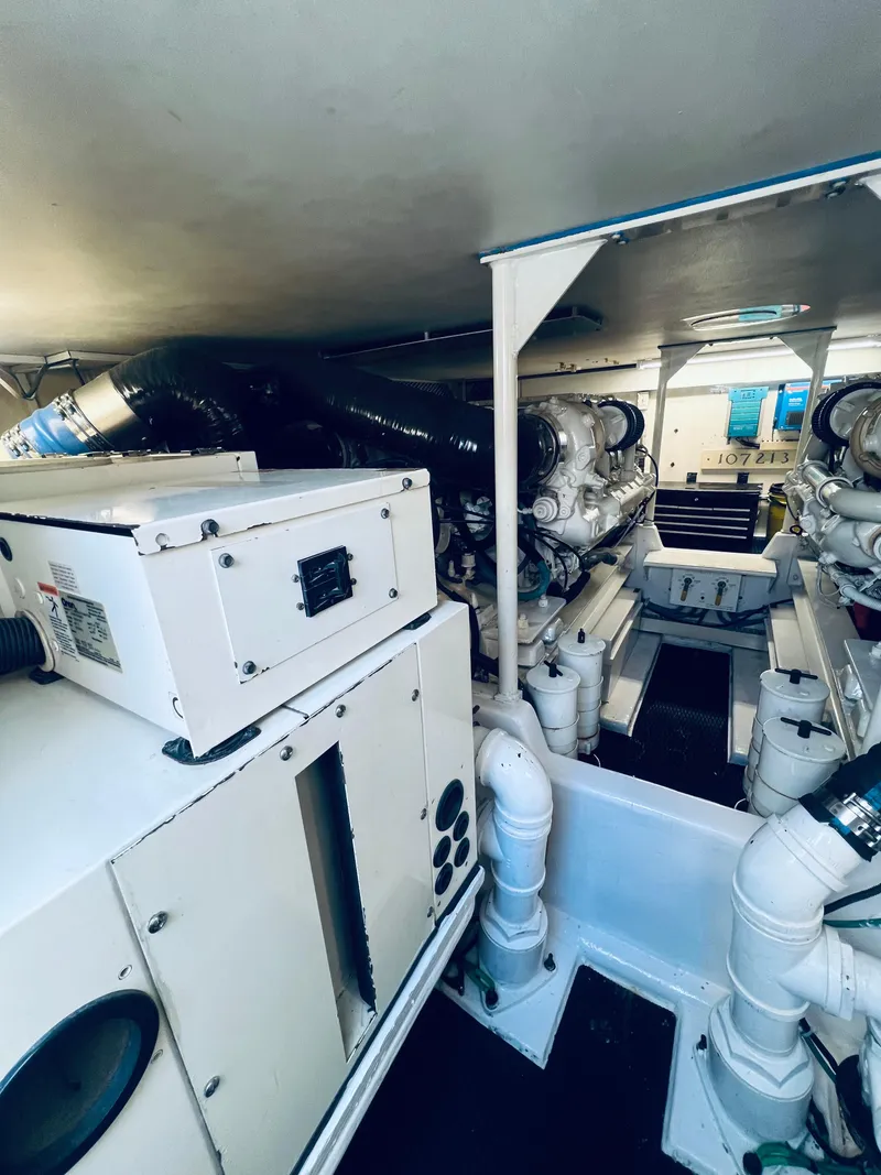 Slide: The Image of Engine room of 1999 Viking Conv Sport Fisher boat, showcasing machinery and equipment. - 35