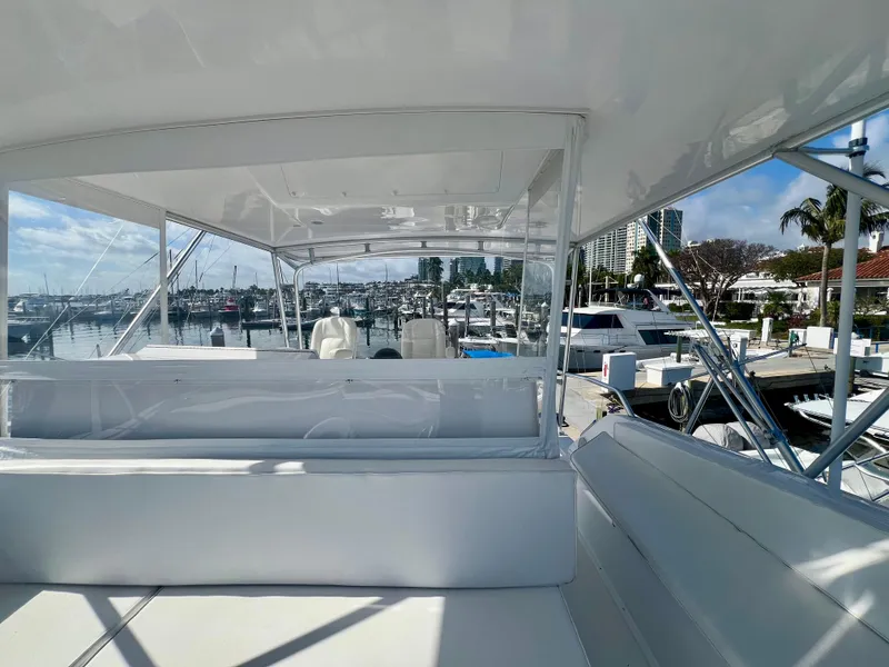 Slide: The Image of 1999 Viking Conv Sport Fisher yacht docked at a marina, showcasing spacious seating and sleek design. - 38