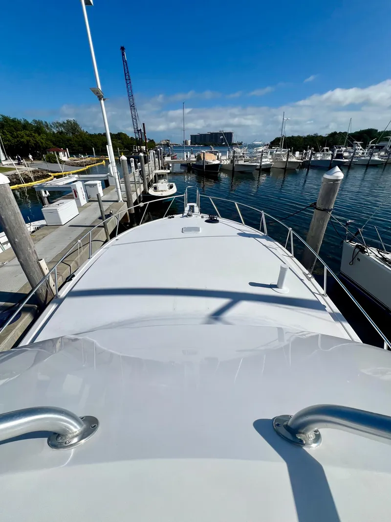 Slide: The Image of 1999 Viking Conv Sport Fisher boat docked at marina under clear blue sky. - 39