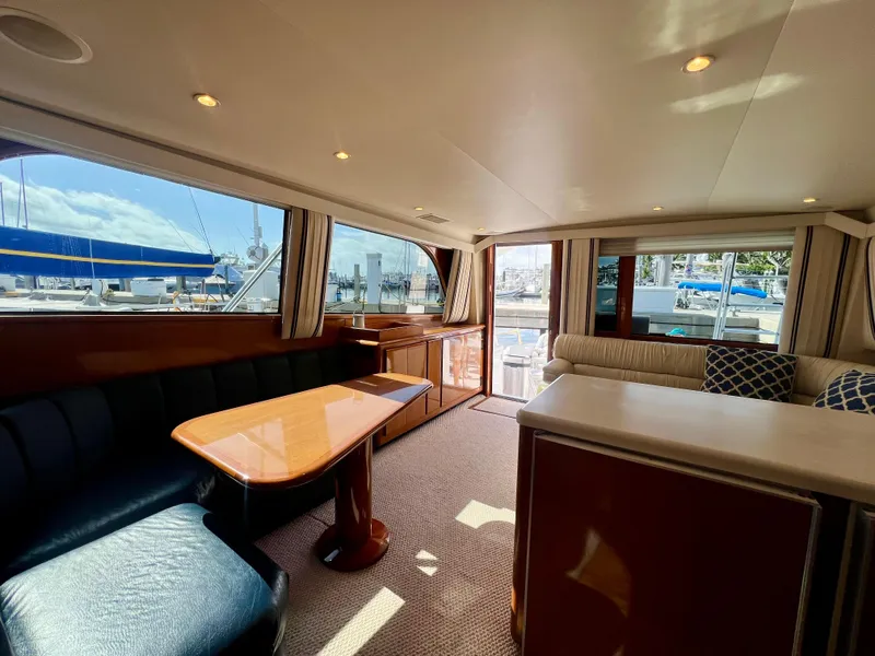 Slide: The Image of Interior of 1999 Viking Conv Sport Fisher yacht with elegant seating and dining area. - 9