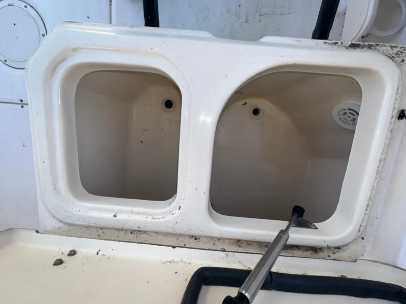 Slide: The Image of Grady-White Seafarer 226 boat storage compartments, 2006 model, with visible drainage holes. - 10