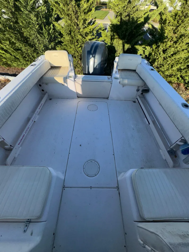 Slide: The Image of 2006 Grady-White Seafarer 226 boat interior with seating and engine view. - 11