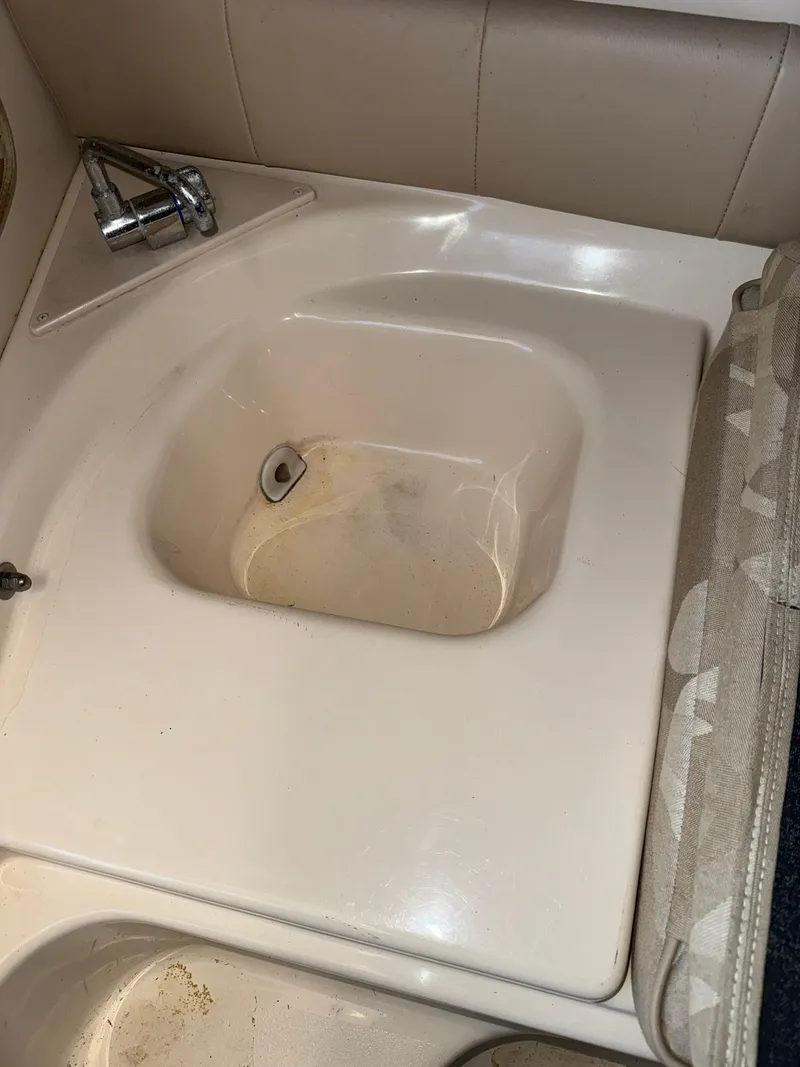 Slide: The Image of 2006 Grady-White Seafarer 226 boat sink with faucet, beige interior. - 14