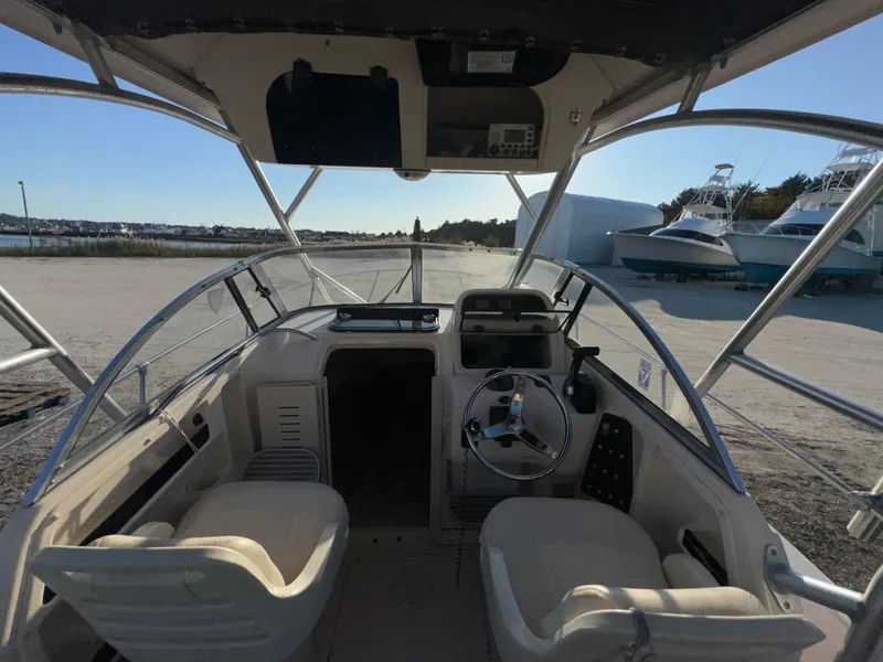 Slide: The Image of 2006 Grady-White Seafarer 226 boat interior with steering wheel and seating. - 6