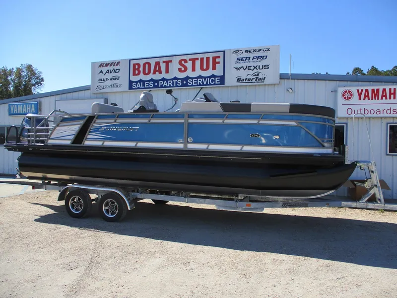 The Image of 2025 Starcraft CX 23 RL pontoon boat on trailer at dealership. - 0