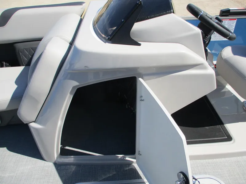 Slide: The Image of 2025 Starcraft CX 23 RL boat console with open storage compartment. - 11