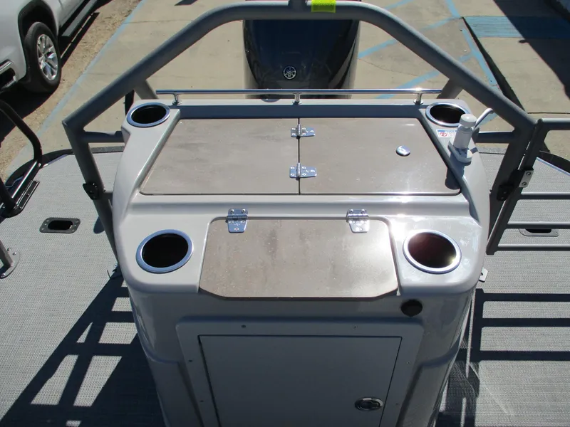 Slide: The Image of Starcraft CX 23 RL 2025 boat console with cup holders and storage compartments. - 12