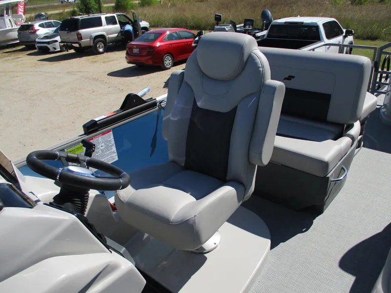 Slide: The Image of 2025 Starcraft CX 23 RL boat interior with plush seating and steering wheel. - 15