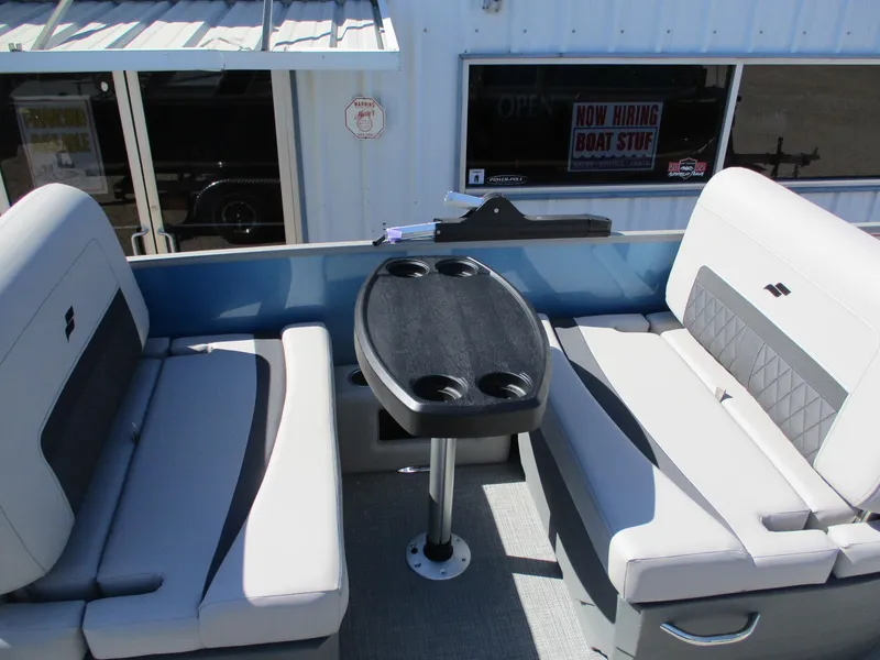 Slide: The Image of 2025 Starcraft CX 23 RL boat interior with seating and table. - 17