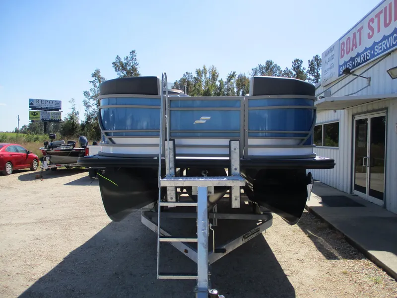 Slide: The Image of 2025 Starcraft CX 23 RL pontoon boat on trailer at dealership. - 2