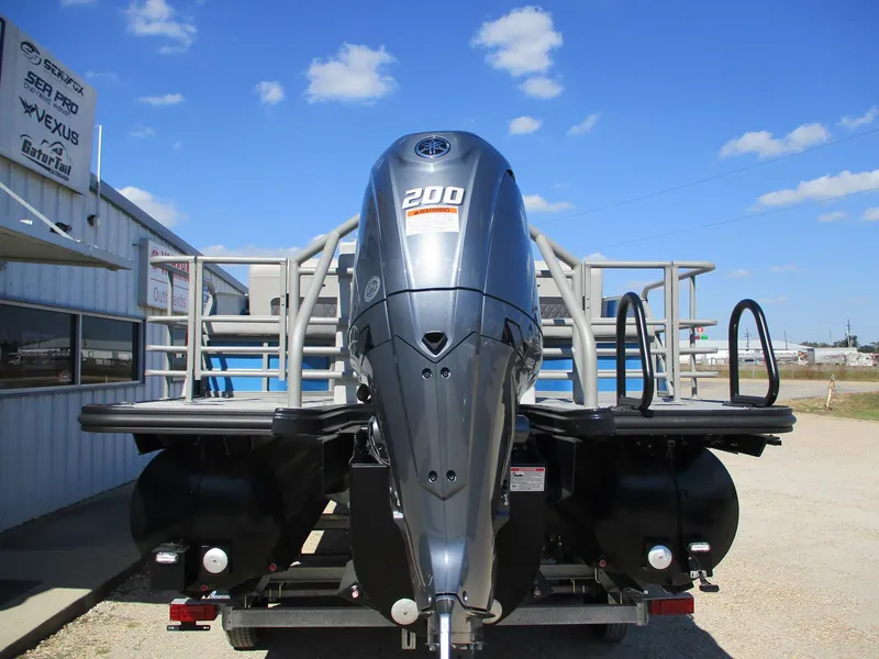 Slide: The Image of 2025 Starcraft CX 23 RL boat with powerful 200 HP engine, parked outdoors. - 7