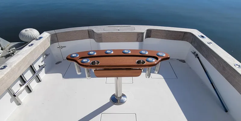 Slide: The Image of L&H 33 boat deck, 2017 model, featuring a wooden fishing rod holder. - 15