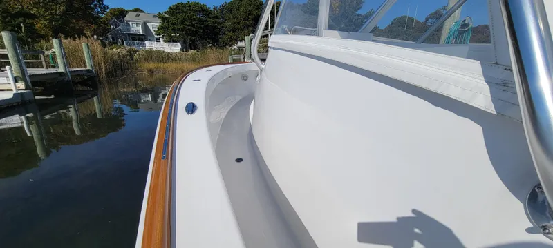 Slide: The Image of 2017 L&H 33 boat docked by calm waters, showcasing sleek design and craftsmanship. - 18