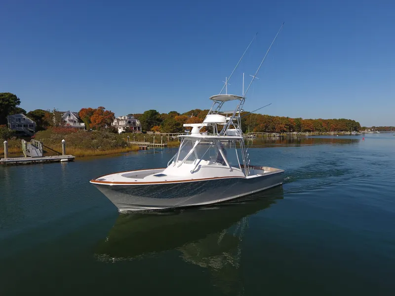 Slide: The Image of 2017 L&H 33 boat cruising on a calm lake with autumn foliage. - 3