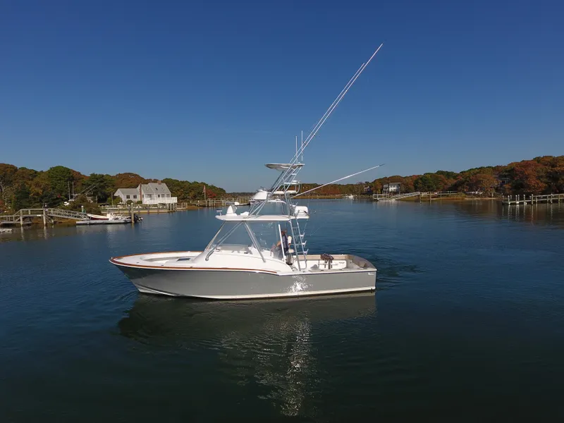 Slide: The Image of 2017 L&H 33 boat on a calm river under clear blue skies. - 35