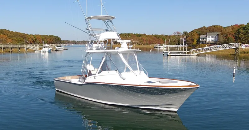 Slide: The Image of L&H 33 boat, 2017 model, cruising on a calm river with autumn foliage. - 4