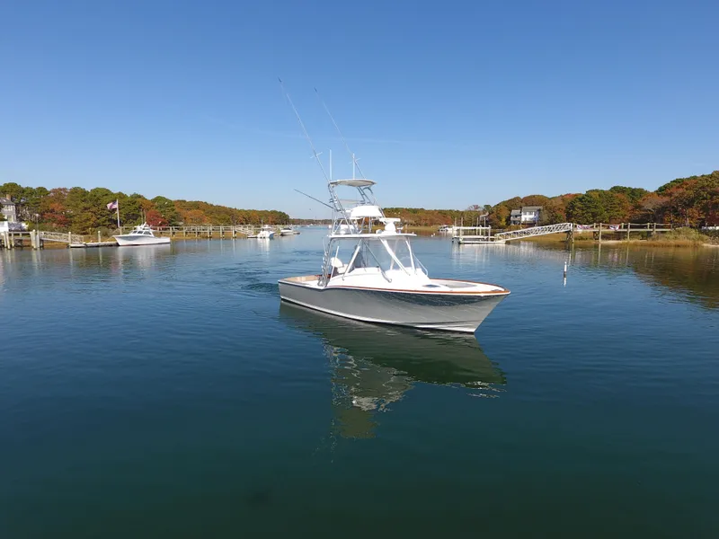 Slide: The Image of 2017 L&H 33 boat cruising on a calm, scenic waterway. - 6