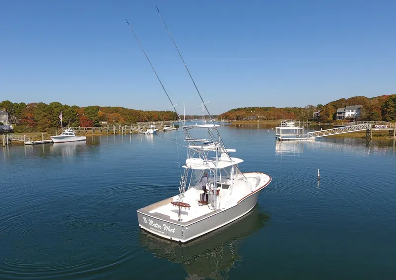 Slide: The Image of L&H 33 boat from 2017 on a calm river with clear skies. - 7