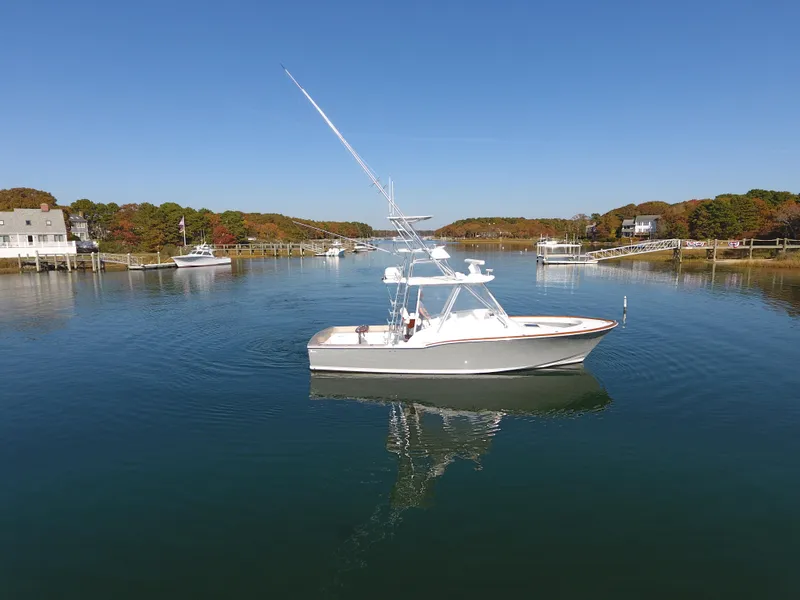Slide: The Image of 2017 L&H 33 boat on calm water under clear blue sky. - 8