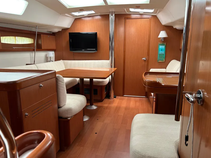 Slide: The Image of Interior of 2008 Beneteau Oceanis 46 yacht with wood finish and cozy seating area. - 12