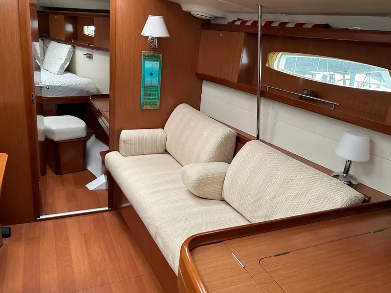 Slide: The Image of Interior of 2008 Beneteau Oceanis 46 yacht with cozy seating and elegant wood finish. - 14