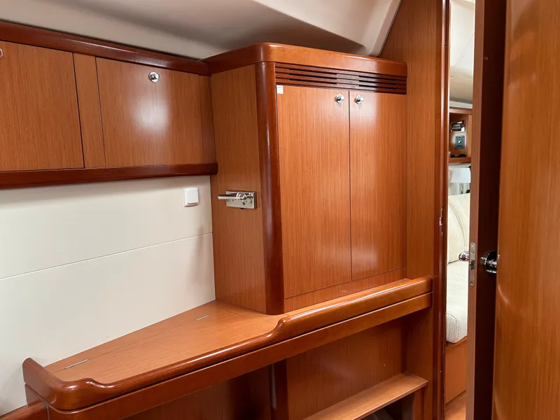 Slide: The Image of Interior of 2008 Beneteau Oceanis 46 yacht with wooden cabinetry and storage space. - 19