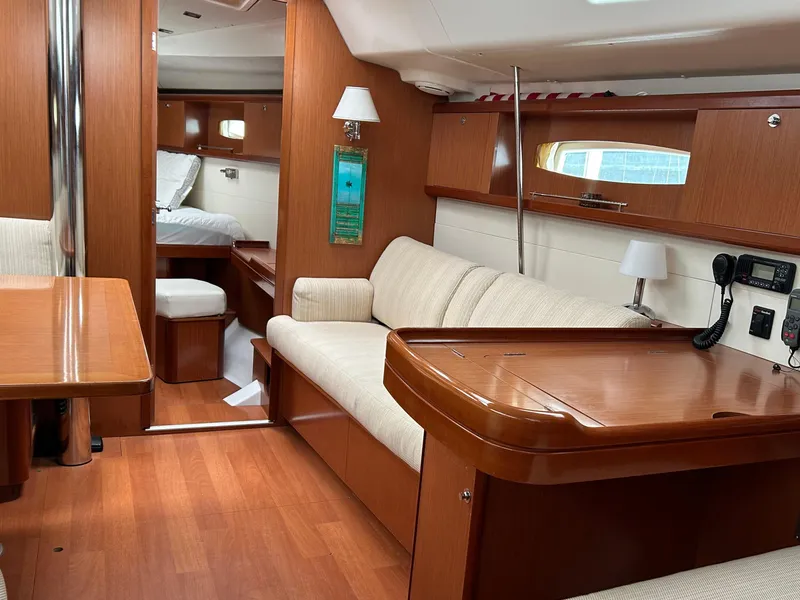 Slide: The Image of Interior of 2008 Beneteau Oceanis 46 yacht, featuring elegant wood finish and comfortable seating. - 23