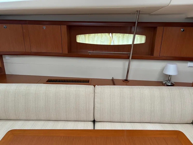 Slide: The Image of Interior of 2008 Beneteau Oceanis 46 yacht with wooden cabinets and beige seating. - 25