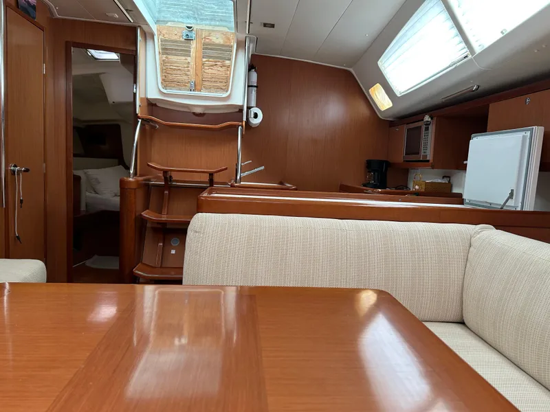 Slide: The Image of Interior of 2008 Beneteau Oceanis 46 sailboat with wooden finish and cozy seating area. - 27