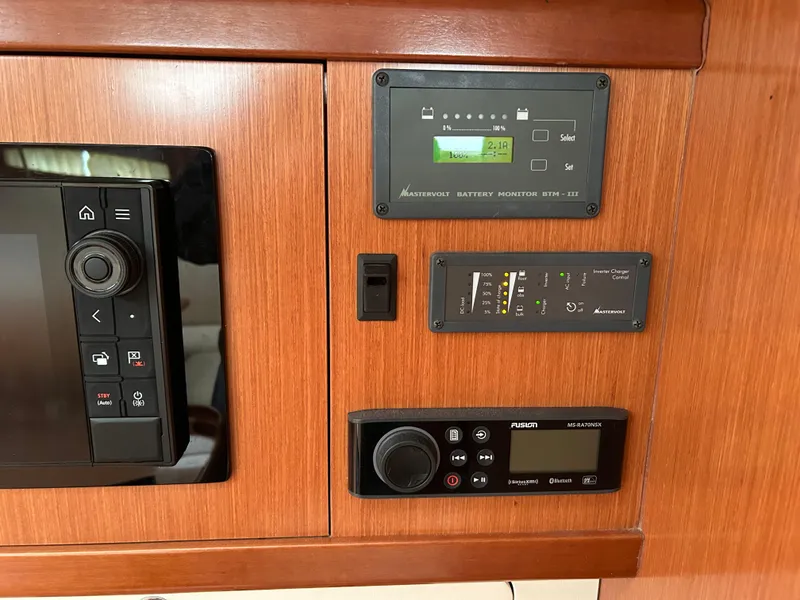 Slide: The Image of Control panel of a 2008 Beneteau Oceanis 46 sailboat with navigation and battery monitors. - 34